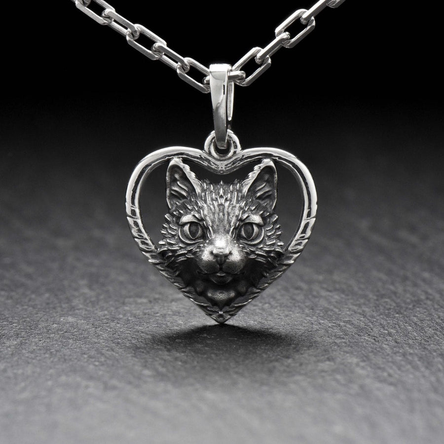 This beautiful and unique pendant features a lovely cat silhouette sitting in a heart-shaped frame. Handcrafted from high-quality sterling silver, this piece is perfect for cat lovers or anyone who appreciates intricate and detailed jewelry. __etsy:7357304418