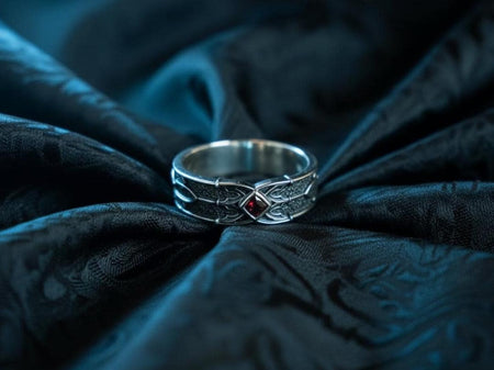 A gothic men’s sterling silver ring featuring a deep red square gemstone set in an ornate fantasy-inspired frame. The textured oxidized background creates contrast that highlights the blade-shaped patterns wrapping around the band. Ideal for gothic fashion lovers, fantasy fans, or as a unique men’s wedding band, this ring blends medieval elegance and modern craftsmanship. __etsy:7473869109