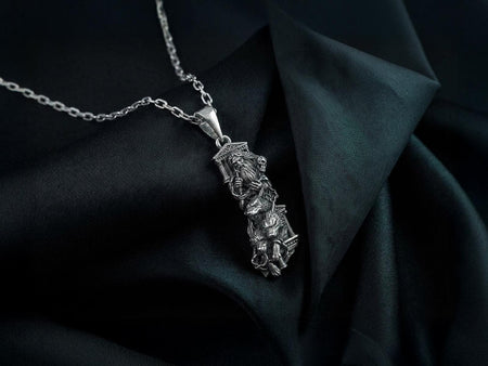 A highly detailed 925 sterling silver pendant of the Greek god Zeus, held gently by a hand wearing a white cotton inspection glove. The rectangular pendant features an arched top and depicts Zeus with a flowing beard and intense expression, grasping a jagged lightning bolt across his chest. An eagle rests at his waist, surrounded by classical fluted columns and a detailed Greek temple at the base, all set against a pure black background. __etsy:8113664175