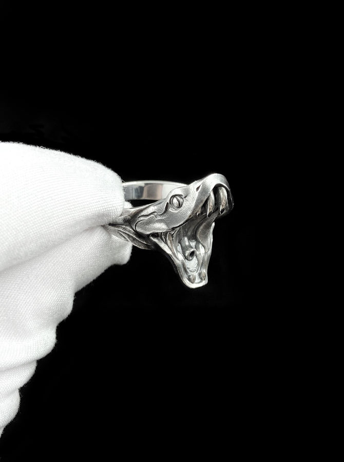 This sterling silver snake head ring captures raw power and hypnotic elegance, featuring a detailed open-mouth serpent design that feels alive on your hand. Crafted for those who embrace bold individuality, this snake ring symbolizes transformation, strength, and fearless self-expression. __etsy:7911125669