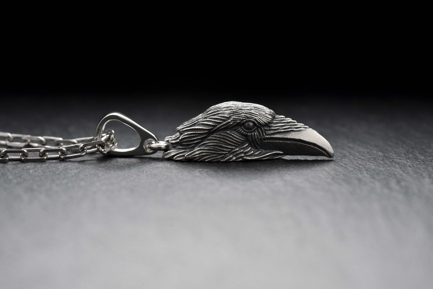 Beautiful silver pendant in the shape of a raven's head. This decoration not only attracts attention with its bright design, but also has a deep symbolic meaning.