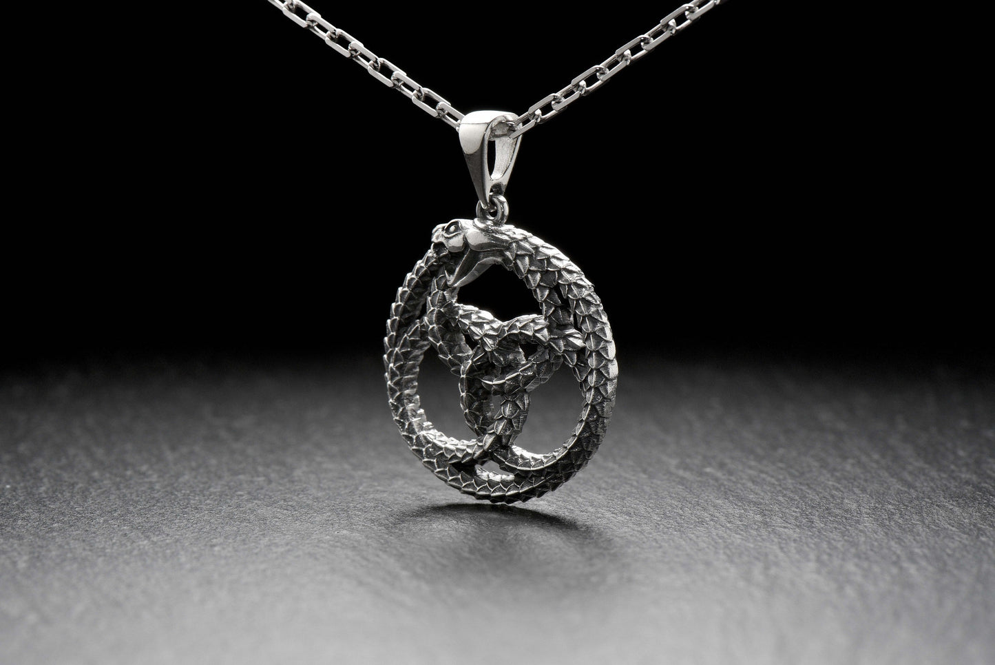 With this silver Ouroboros pendant, you'll always have the ancient legend close to your heart. We offer modern twist on a classic symbol of wisdom and prosperity. __etsy:4365753512