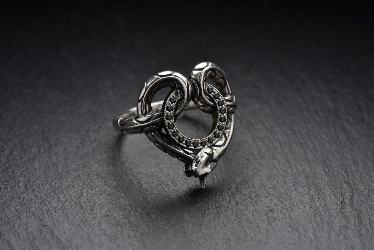With its unique and eye-catching design, this ring is the perfect way to add some edgy elegance to your style. The snake design adds a touch of danger and intrigue, while the stone circle-road adds a touch of sophistication and class. (etsy image id: 4413045871)