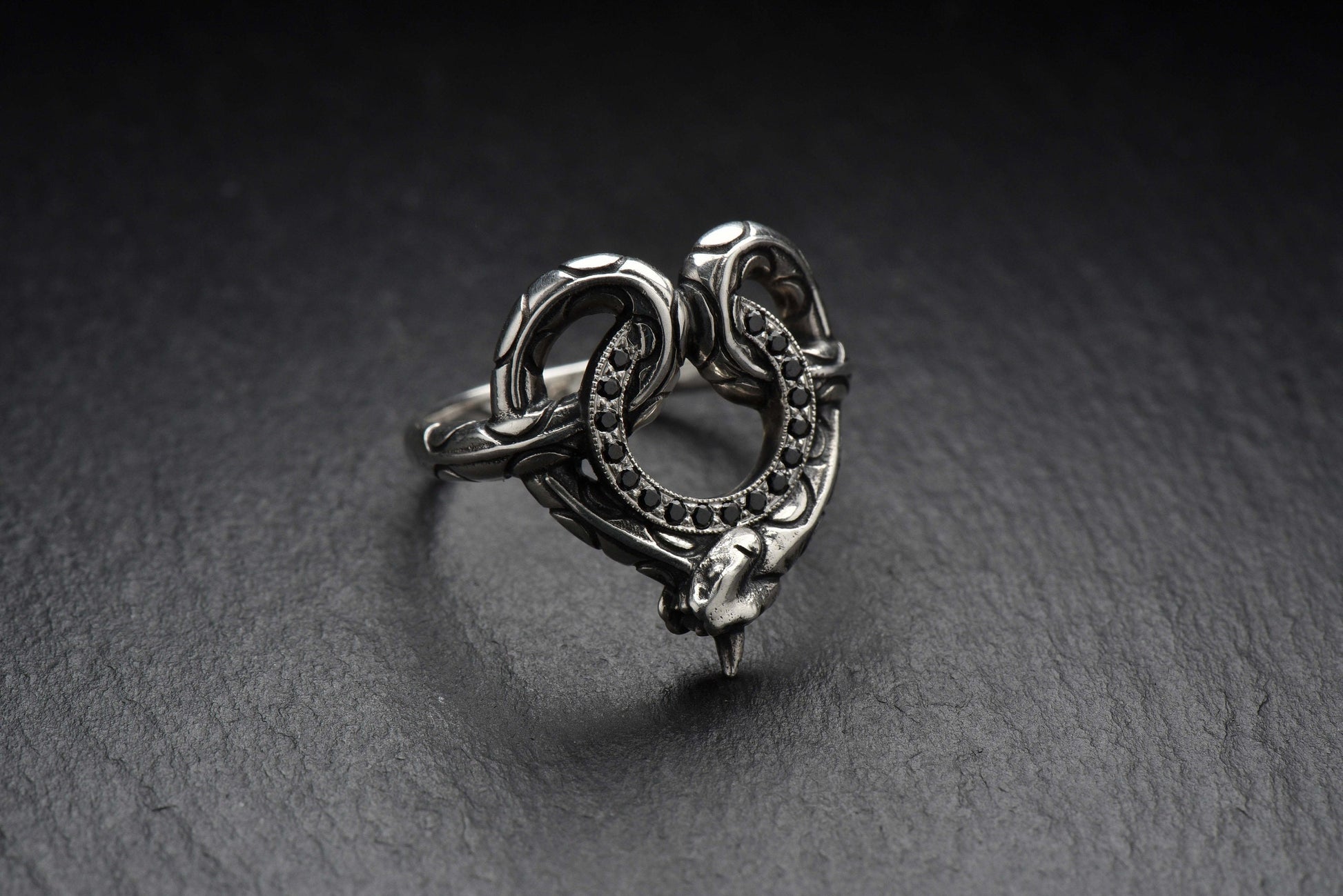 With its unique and eye-catching design, this ring is the perfect way to add some edgy elegance to your style. The snake design adds a touch of danger and intrigue, while the stone circle-road adds a touch of sophistication and class. (etsy image id: 4413045871)