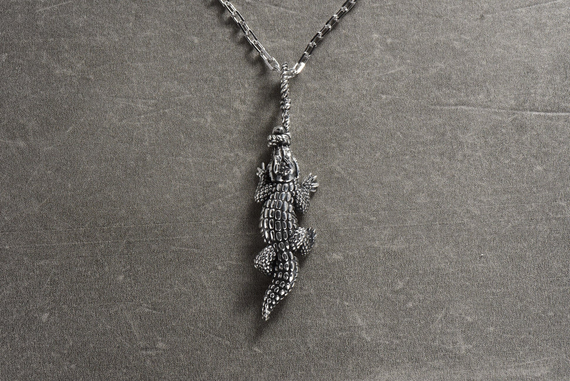 The crocodile is a fascinating animal with a rich symbolism in many cultures. This pendant features a beautifully detailed crocodile design, with intricate scales and textures that bring it to life. (etsy image id: 4421977883)
