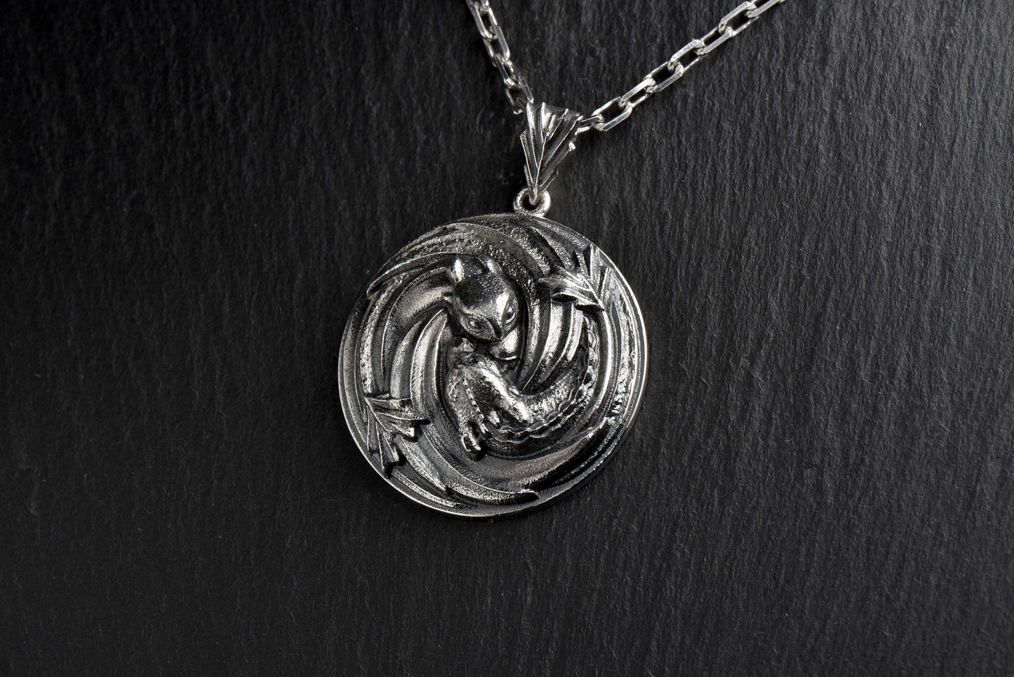 Looking for a unique and stylish accessory to add to your jewelry collection? Check out our Sterling Silver Dragon pendant! With intricate detailing and a fierce design, this piece is sure to make a statement wherever you go. (etsy image id: 4749348320)