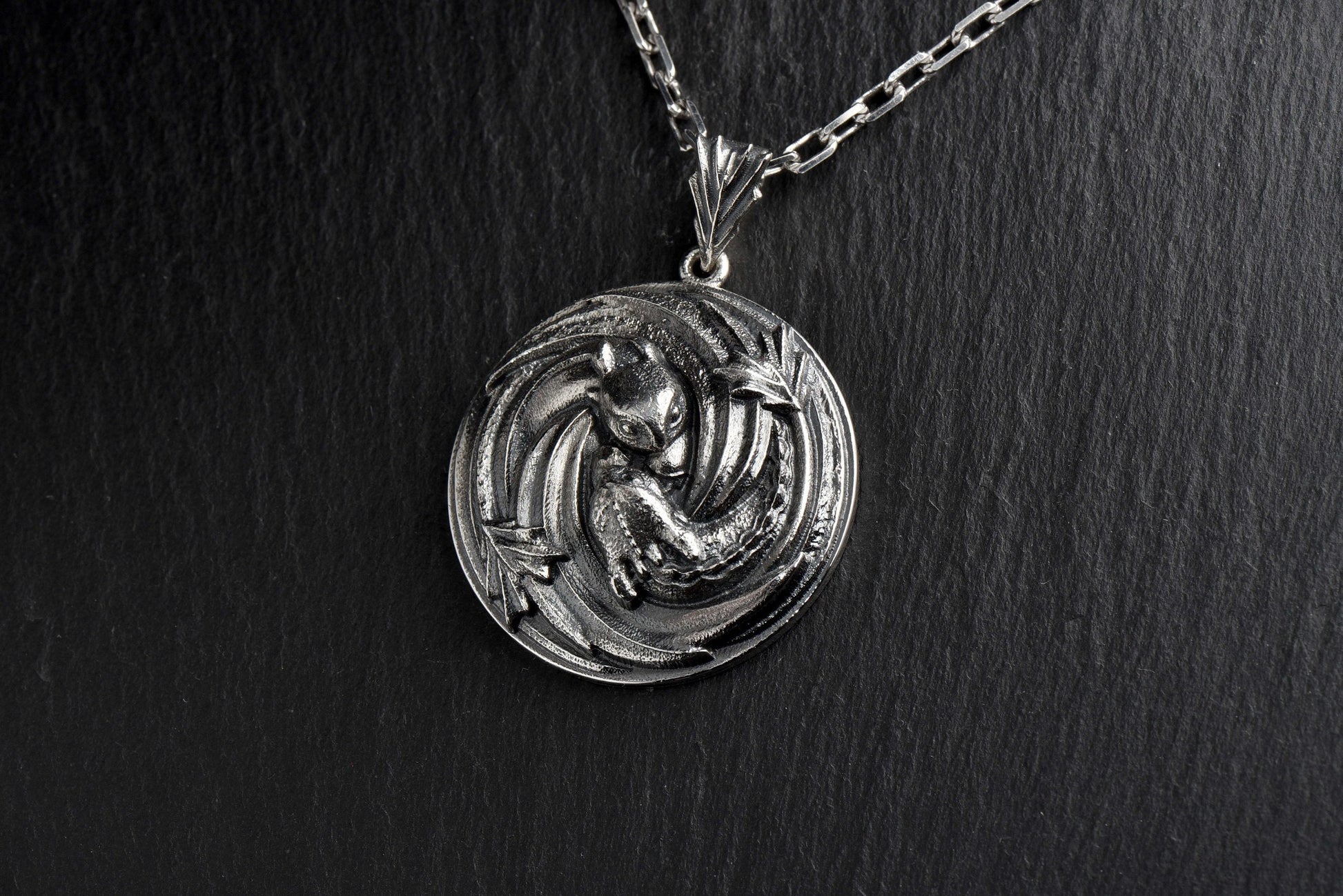 Looking for a unique and stylish accessory to add to your jewelry collection? Check out our Sterling Silver Dragon pendant! With intricate detailing and a fierce design, this piece is sure to make a statement wherever you go. (etsy image id: 4749348320)