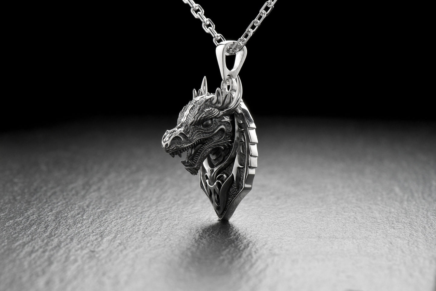 Check out this stunning silver dragon pendant! Handcrafted by skilled artisans, this intricate piece features a beautifully detailed dragon design that is sure to catch the eye and spark your imagination. (etsy image id: 4852837307)