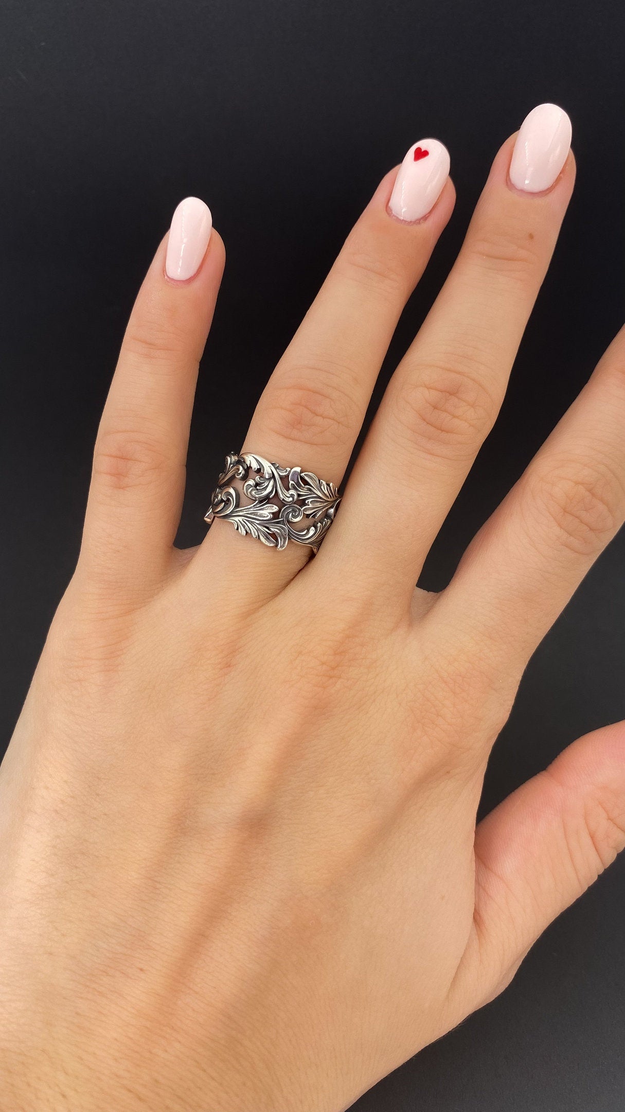 This stunning ring features intricate patterns meticulously crafted in sterling silver, showcasing a symphony of delicate lines, curves, and shapes. The patterns create a mesmerizing visual display, adding a touch of sophistication to your look. (etsy image id: 5044343854)