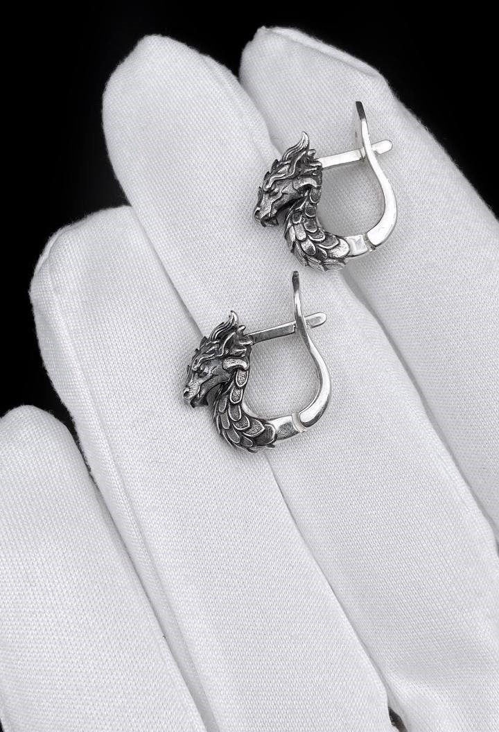 These handcrafted sterling silver dragon earrings are inspired by legends and ancient symbolism. Representing wisdom, strength, and mystical power, each earring captures the spirit of the dragon in exquisite detail. (etsy image id: 5611958816)