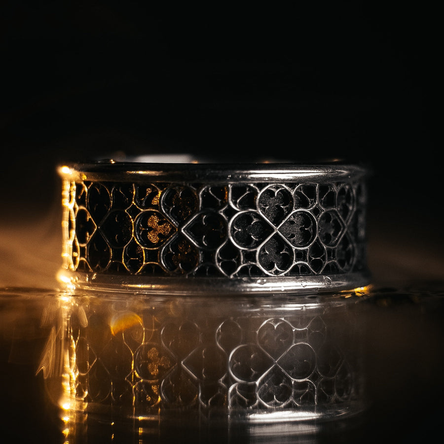 This view focuses on the tactile quality of the 925 sterling silver. The raised lattice framework is smooth and rounded, ensuring it won't snag on clothing, while the black background has a stippled, grainy texture that absorbs light. The image captures the "chiaroscuro" effect of the metalwork—the interplay of light silver and dark shadow—which gives the ring a rugged, masculine feel suitable for daily wear. (etsy image id: 6052185804)