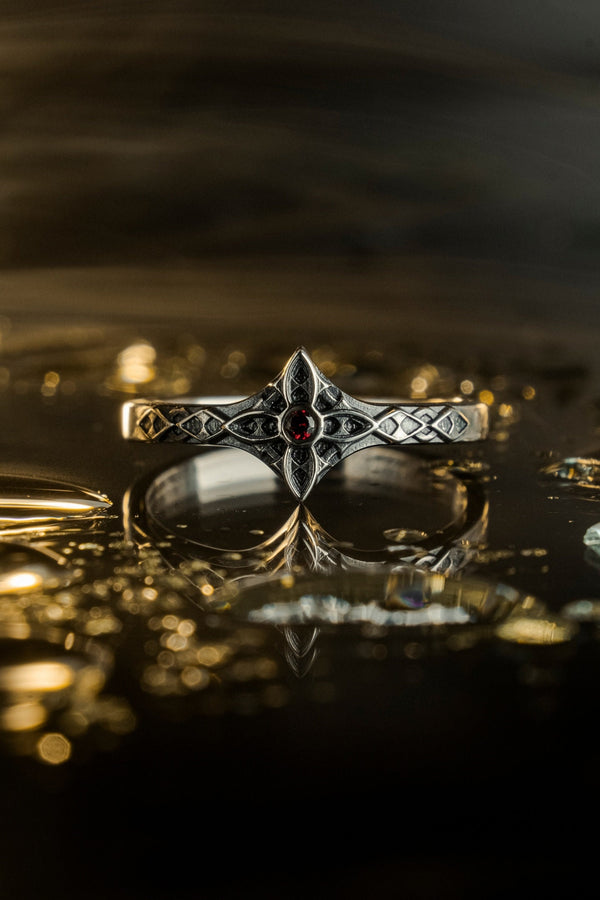 A professional studio photograph of a matching two-piece sterling silver wedding ring set. Both rings feature a prominent, raised Greek-style cross motif in the center, which holds a round, bezel-set white crystal. The interior of the cross arms has a fine, cross-hatched grid texture. Along the sides of the high-polished silver bands are recessed, four-lobed quatrefoil shapes. The rings are presented against a pitch-black background, making the p __etsy:8051335185