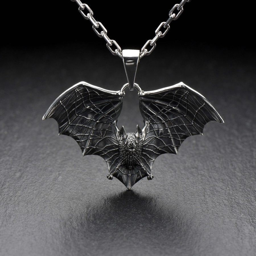 Featuring a detailed bat with outstretched wings, our unique design is sure to stand out. Don't let the darkness keep you down—power up your style with a silver bat pendant today! (etsy image id: 6086867201)