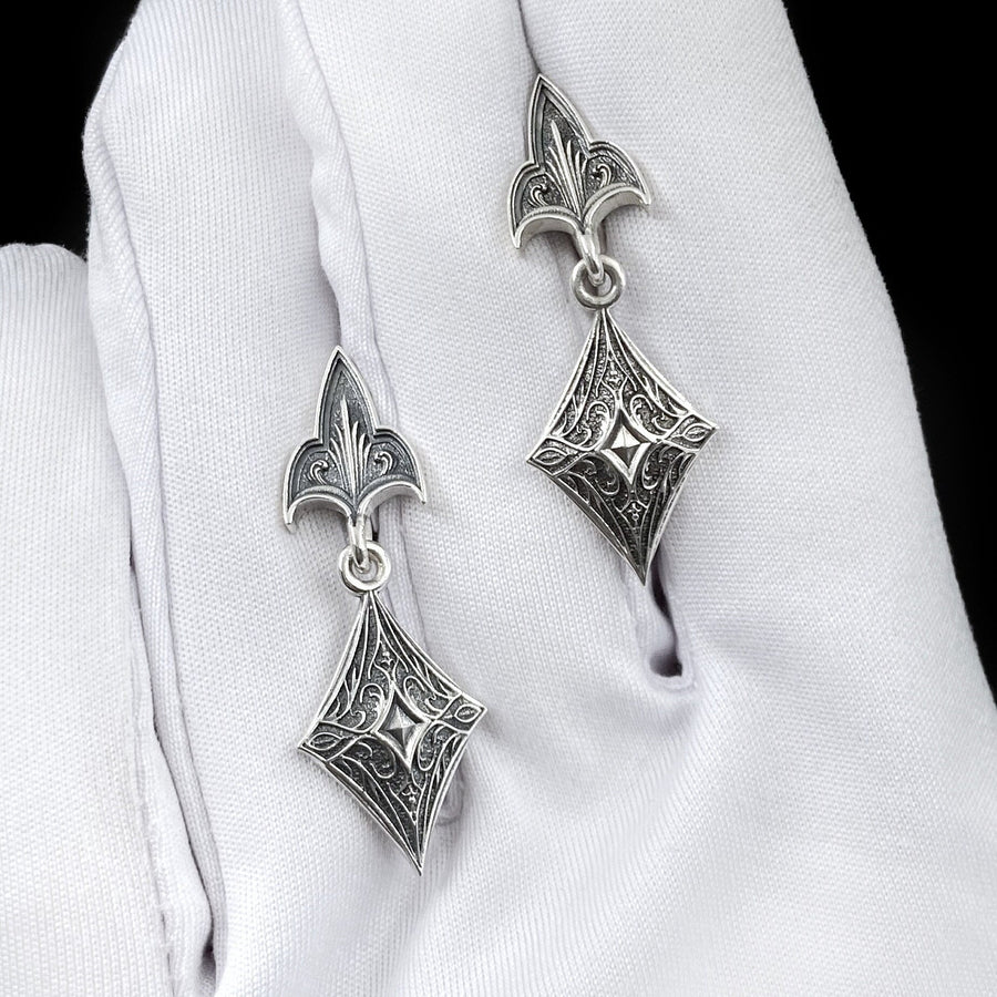 Embrace the dark allure of Gothic fashion with our Sterling Silver Gothic Earrings. Crafted with meticulous attention to detail, these earrings exude sophistication and mystique, perfect for those who appreciate the darker side of elegance. The mood is regal and sophisticated, appealing to fans of "Royal Core" aesthetics, historical dramas, or Victorian fashion. (etsy image id: 6150688147)