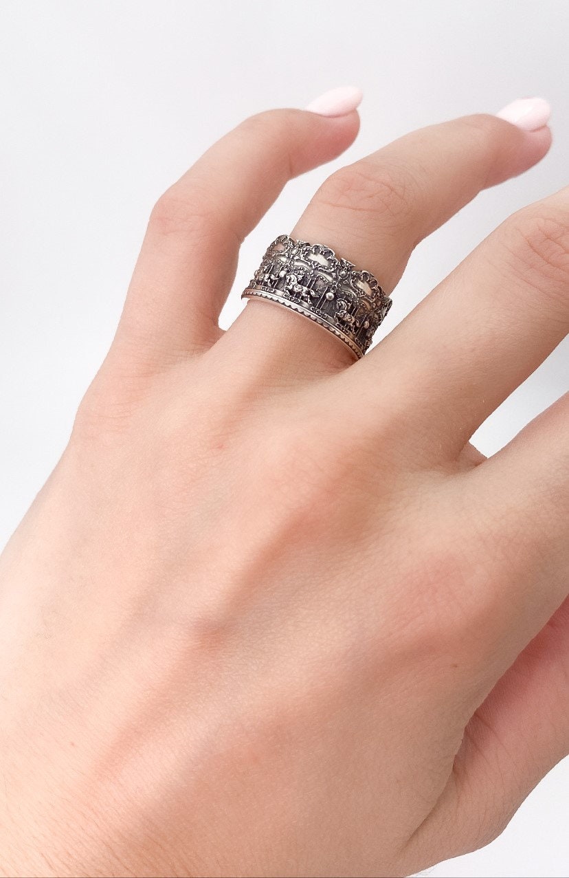 Crafted with precision and attention to detail, this sterling silver ring captures the essence of a carousel's charm. The intricately designed carousel horses gracefully encircle the band, creating a captivating and nostalgic aesthetic. (etsy image id: 7039404429)