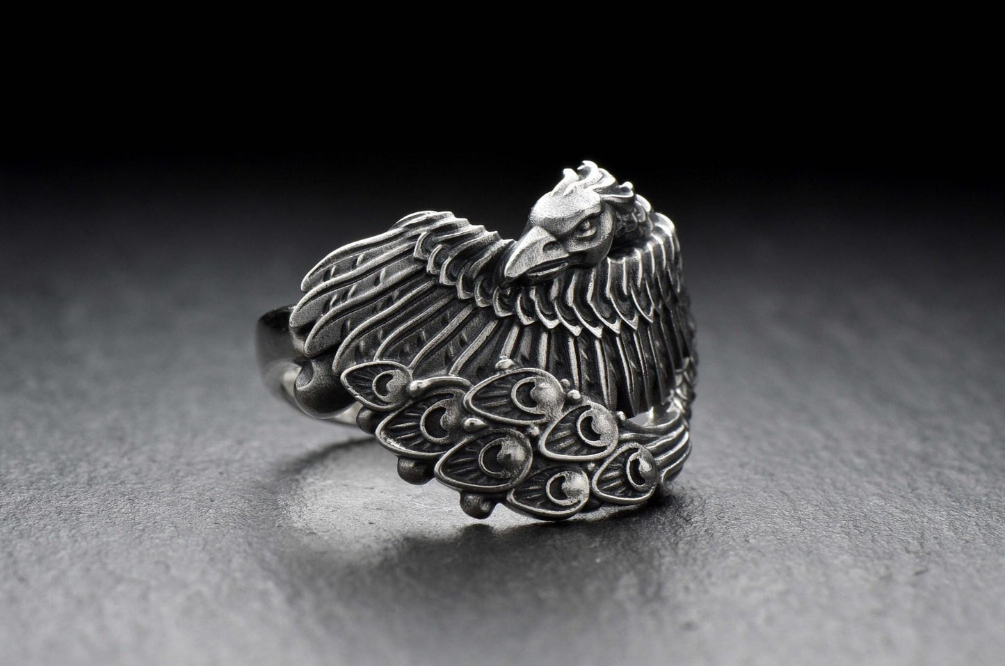 Crafted out of sterling silver, this unique design depicts a mystic bird with a tail shaped like flames, capturing the very essence of rebirth and resurrection. (etsy image id: 7048159509)