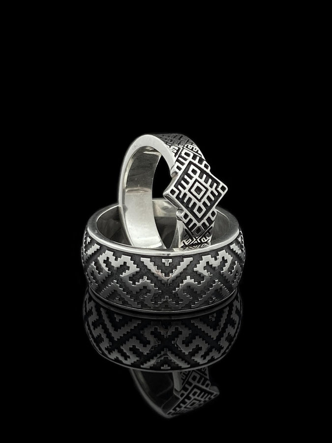 This close-up demonstrates the "relief" texture of the ring. The pattern is not merely etched but deeply cast, with significant height difference between the silver lines and the black background. The 925 sterling silver is substantial and thick. The oxidation is uniform and matte, designed to withstand daily wear without fading, creating a permanent "shadow" that defines the intricate geometry. (etsy image id: 7206997519)