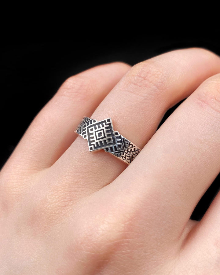 This close-up demonstrates the "relief" texture of the ring. The pattern is not merely etched but deeply cast, with significant height difference between the silver lines and the black background. The 925 sterling silver is substantial and thick. The oxidation is uniform and matte, designed to withstand daily wear without fading, creating a permanent "shadow" that defines the intricate geometry. (etsy image id: 7206997519)