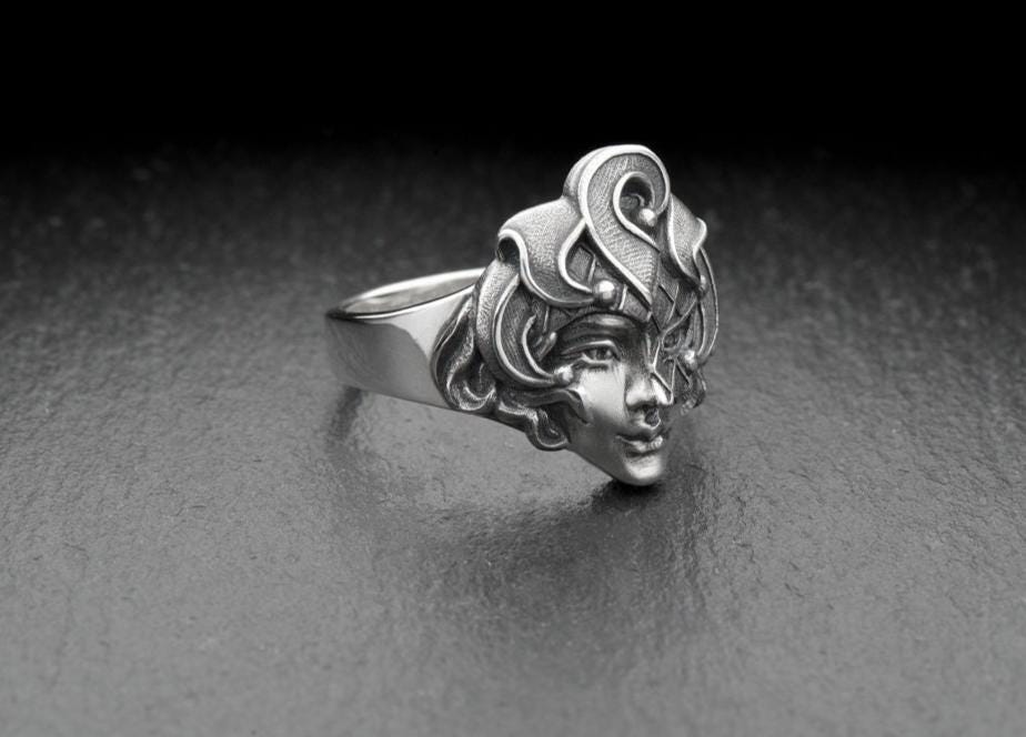 This silver ring depicts a harlequin - a symbol of theater and entertainment. It is ideal for lovers of theatrical art and those who like to attract attention with their unusual style. (etsy image id: 7260347699)