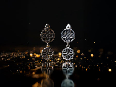 Ideal for both daily wear and special events. Order now and unleash your dark beauty.
Sterling Silver Gothic Earrings | Gothic Earrings | Medieval jewelry | Gothic gift, A clean studio shot of a pair of articulated sterling silver earrings on a reflective black surface. The top section is a circular stud featuring a four-lobed "quatrefoil" motif with a cross-hatched, textured interior. The bottom section is a hanging openwork charm in t (etsy image id: 7267920961)