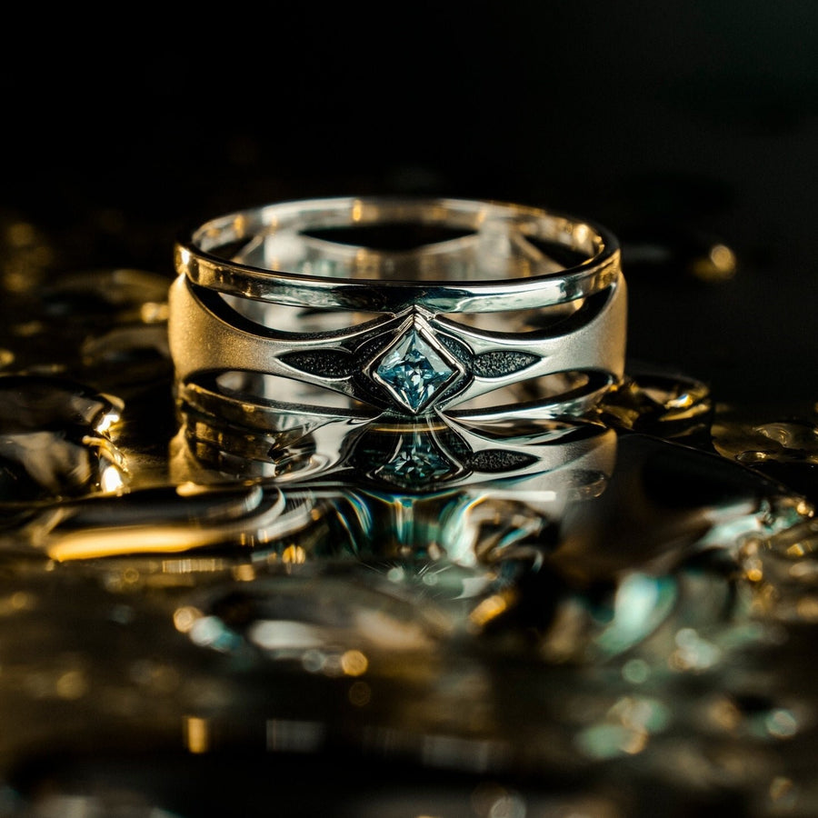 Mysterious and enchanting, this gothic silver ring is handcrafted with delicate detailing and a gemstone that adds a striking contrast to its intricate design.
A dramatic sterling silver ring with a central square blue gem, surrounded by carved details reminiscent of gothic architecture. Ideal for wearers seeking distinctive jewelry that stands apart from classic designs. (etsy image id: 7283442213)