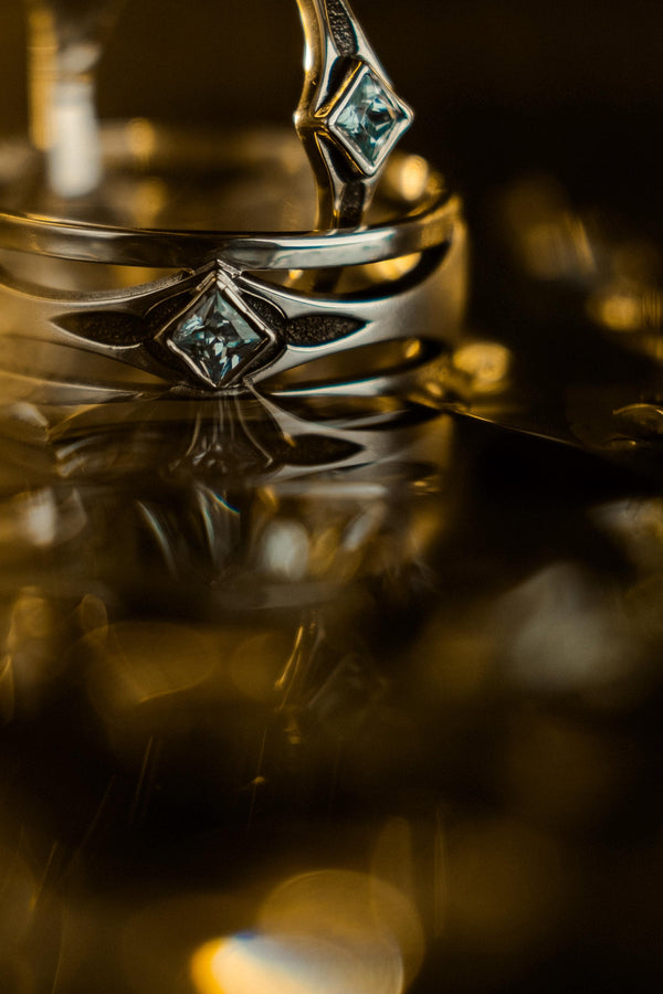 Mysterious and enchanting, this gothic silver ring is handcrafted with delicate detailing and a gemstone that adds a striking contrast to its intricate design.
A dramatic sterling silver ring with a central square blue gem, surrounded by carved details reminiscent of gothic architecture. Ideal for wearers seeking distinctive jewelry that stands apart from classic designs. (etsy image id: 7283442213)