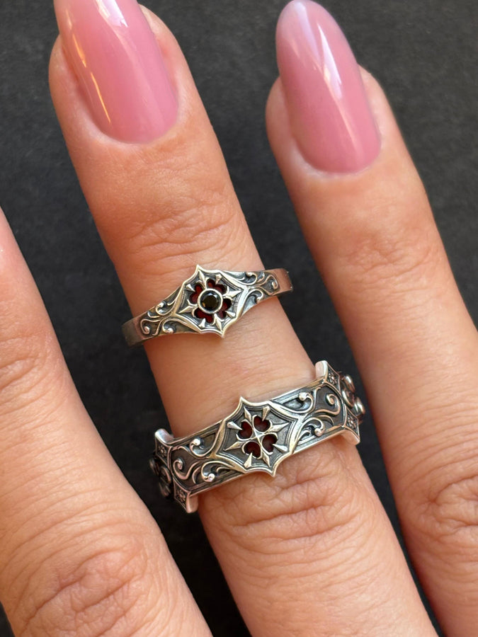 Handmade sterling silver band with an intricate gothic crown motif in the center, framed by swirling ornamental engravings. The deep relief and antique darkened finish evoke historic cathedral carvings. Ideal for customers seeking dark romantic jewelry, gothic accessories, medieval wedding rings, and meaningful silver bands with symbolic architecture-inspired designs. (etsy image id: 7423455351)