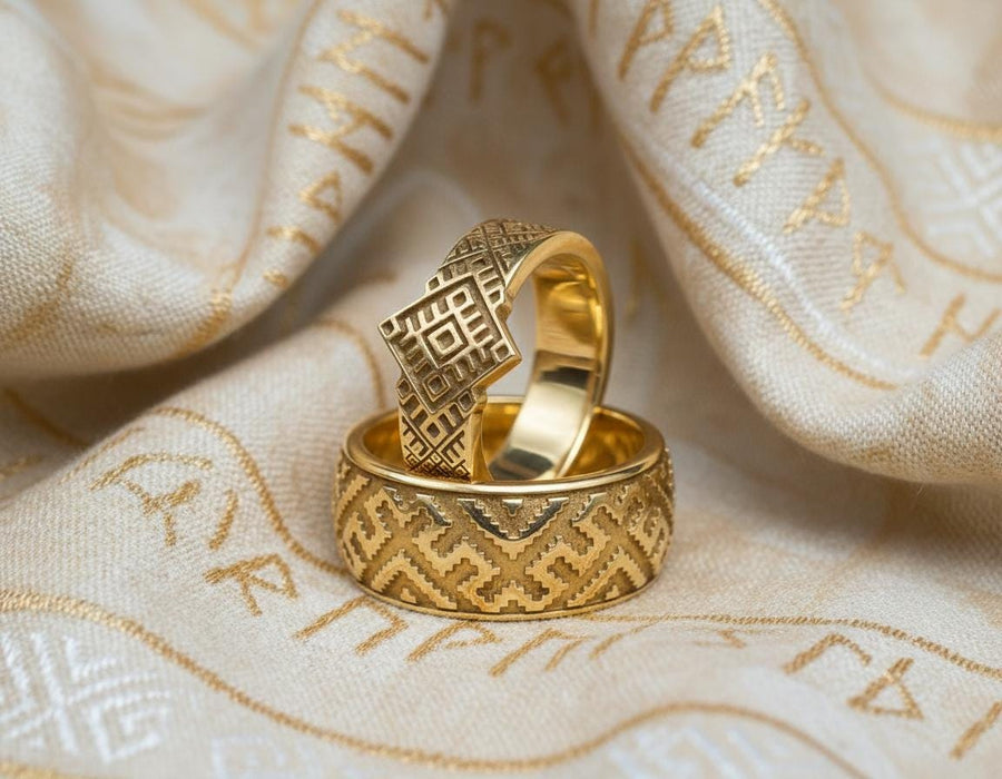 A studio shot of a two-piece sterling silver ring set with a high-contrast black and silver finish. The standing ring features a square, diamond-shaped face created by stepped geometric lines. The lying ring is a wide band with a continuous "zig-zag" or "step" pattern running around the circumference. The design mimics the look of cross-stitch embroidery or pixelated ancient art rendered in metal.