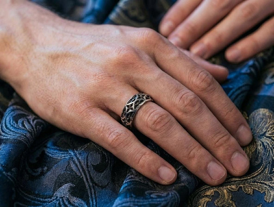 The image demonstrates the seamless nature of the pattern, which wraps around the ring without a visible break. This indicates high-quality casting and mold-making. The rim is substantial but rounded, preventing the ring from digging into the finger. It showcases a balance between rugged "blacksmith" aesthetics and fine jewelry finishing. (etsy image id: 6100248085)
