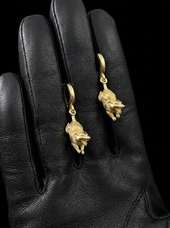 A close-up studio shot of sterling silver dangle earrings featuring detailed opossums. The animals are depicted with open mouths and textured fur, hanging from polished lever-back clasps. The metal is heavily oxidized in the recesses to enhance the realistic, rugged appearance of the marsupials against a white fabric background.