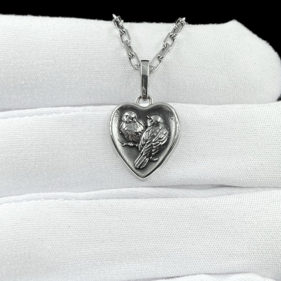 This silver titmouse heart pendant necklace captures tenderness, closeness, and quiet romance in a piece that feels deeply personal. The heart-shaped pendant with two titmice creates a meaningful design that symbolizes love, warmth, and connection. (etsy image id: 7963557331)