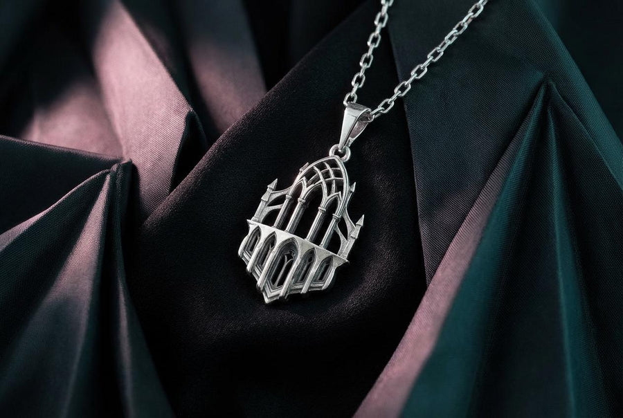 This macro image highlights the masterful craftsmanship of the solid 925 sterling silver casting. The artisan has flawlessly translated monumental stone architecture into miniature metalwork. The columns are smooth and precise, while deep sulfur oxidation creates a permanent matte black shadow in the open recesses of the arches. This traditional antiquing technique gives the gothic relic pendant the weathered, enduring texture of an actual historical cathedral fragment. (etsy image id: 7979026828)